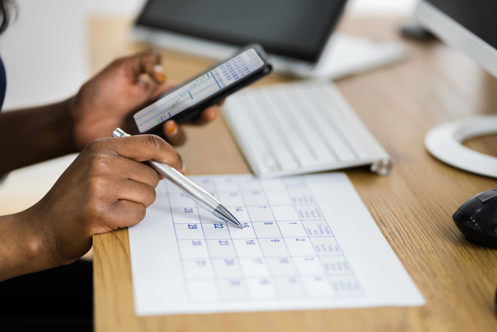 A front office employee works to fit patients into the appointment schedule using modified wave scheduling.